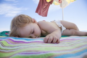 summer sleep schedule, baby sleeping on beach