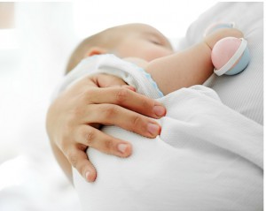 cuddling newborn baby fourth trimester